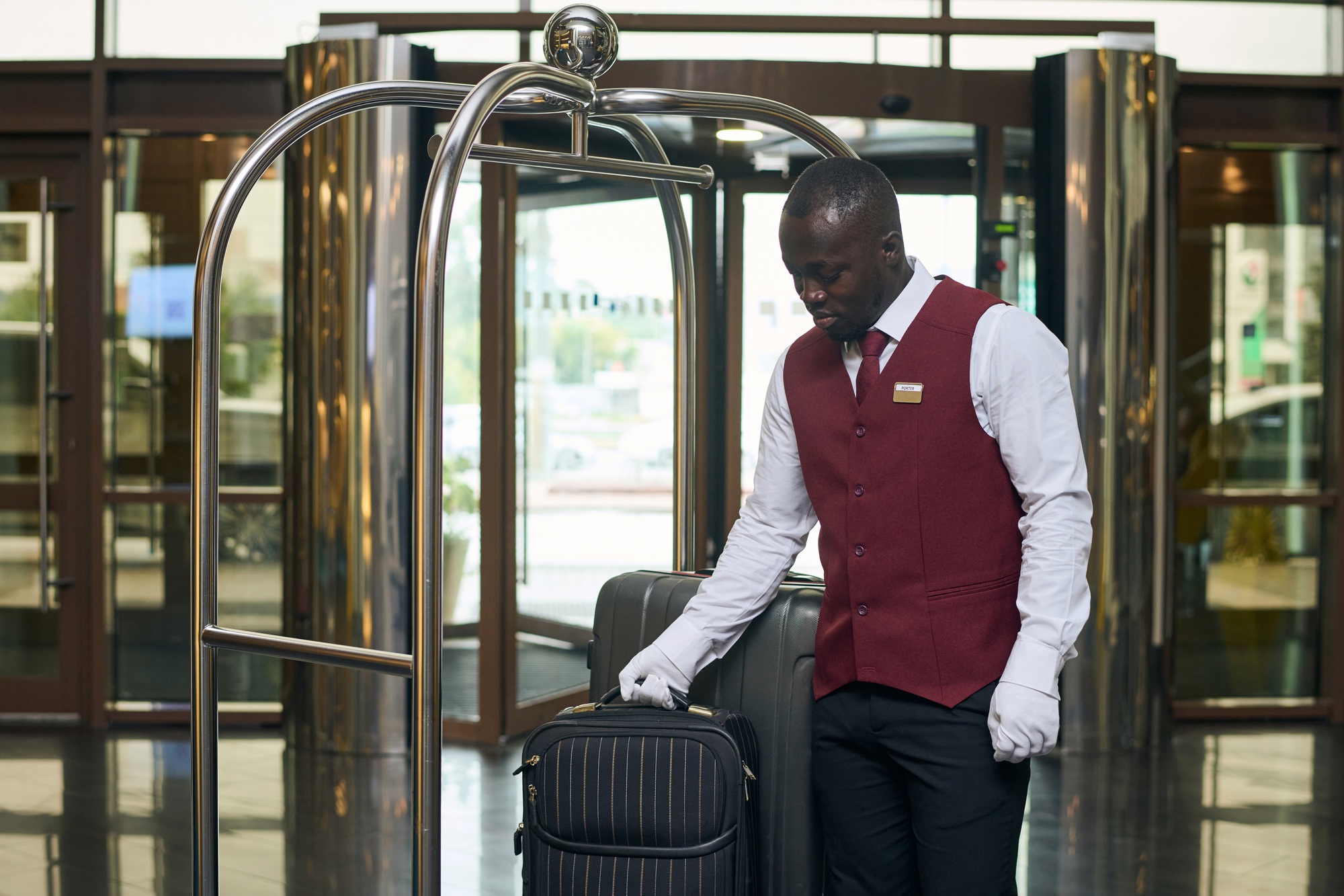 Doorman with luggage in lobby of the hotel